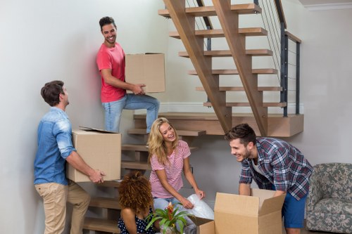 Professional office movers handling furniture