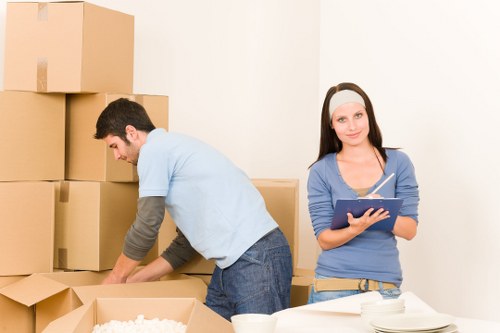 Professional movers handling office equipment